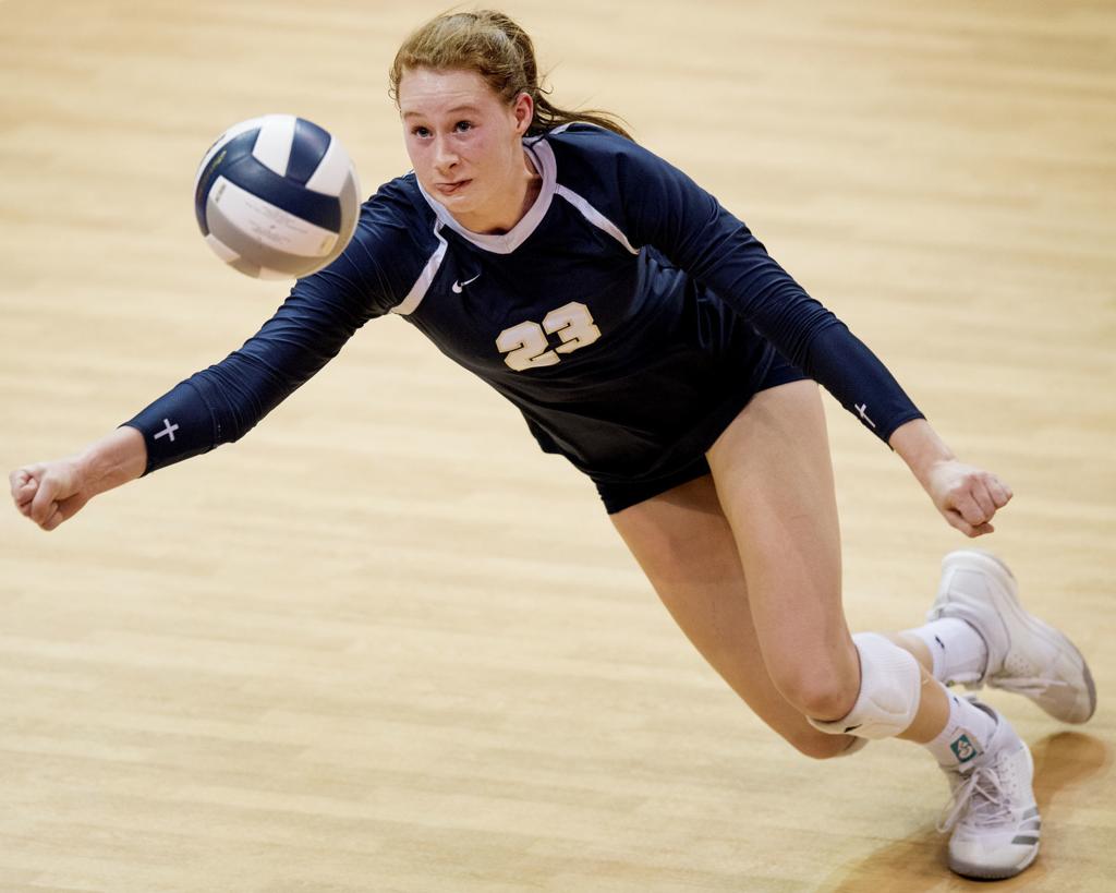 Marriah dives for a ball with one arm during the State Championship