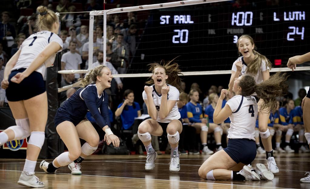 Team falls to the ground as they celebrate winning the state semi final game.