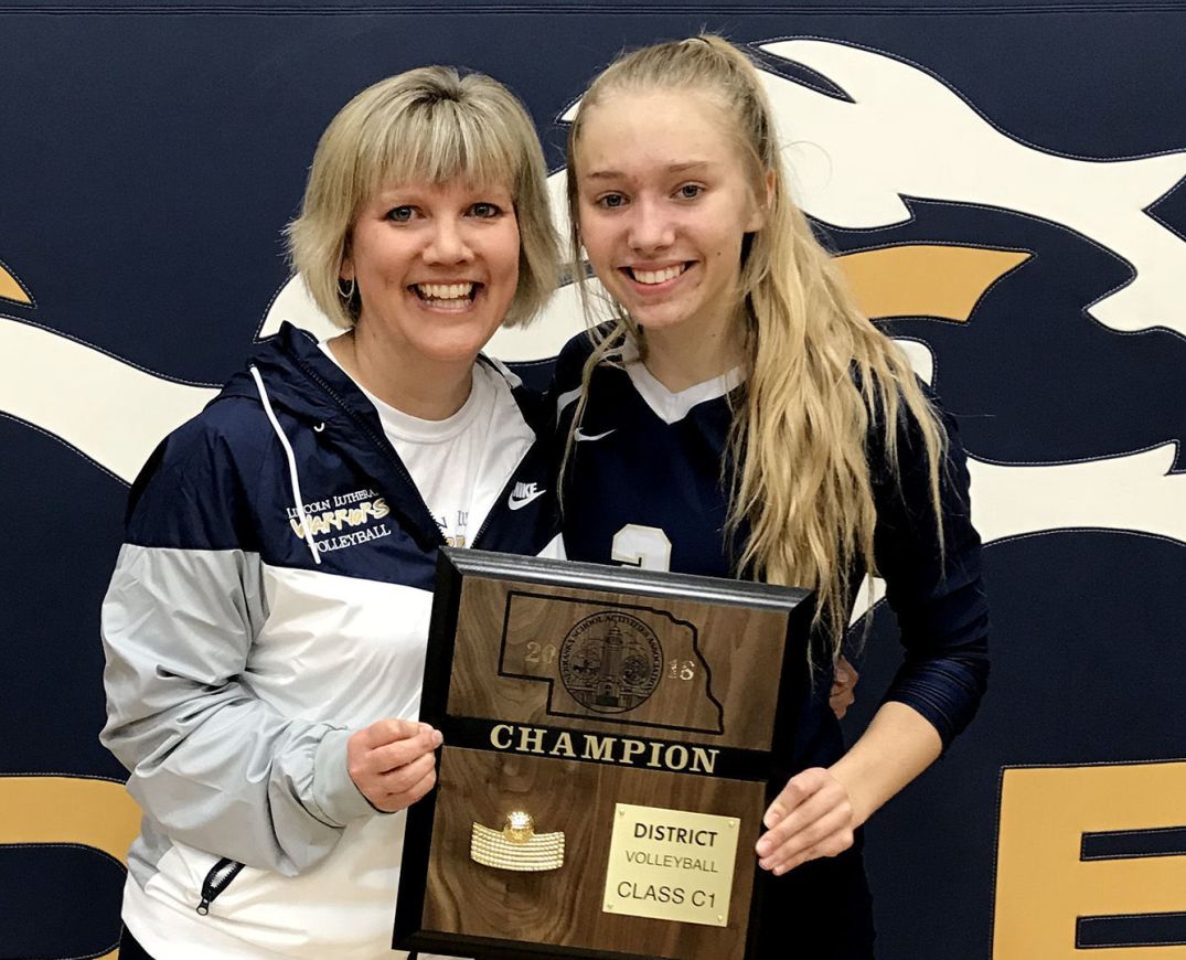 Hope and Stacy pose with the district plaque.